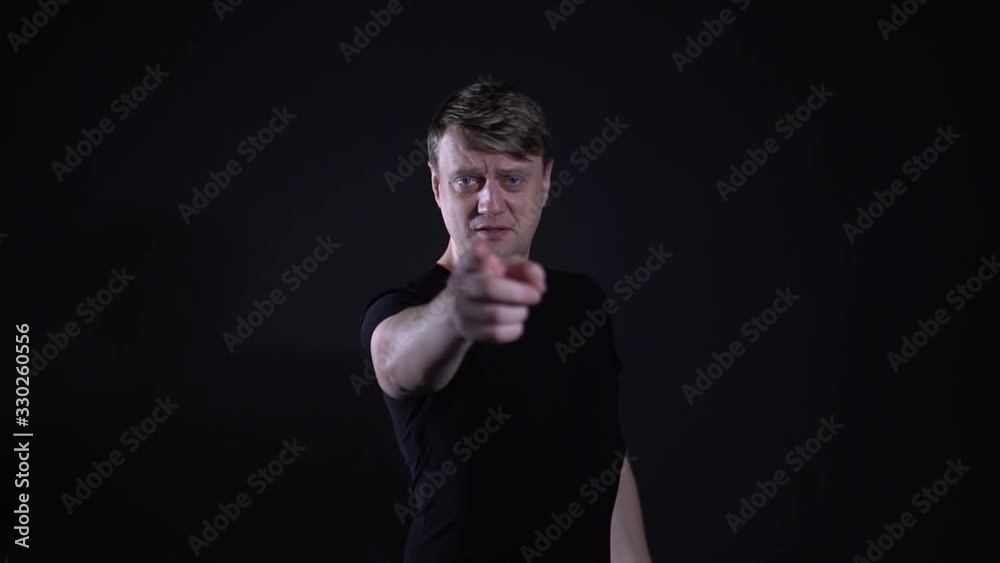 Young man pointing his finger and brutal is in place Young man pointing his finger and brutal is in place