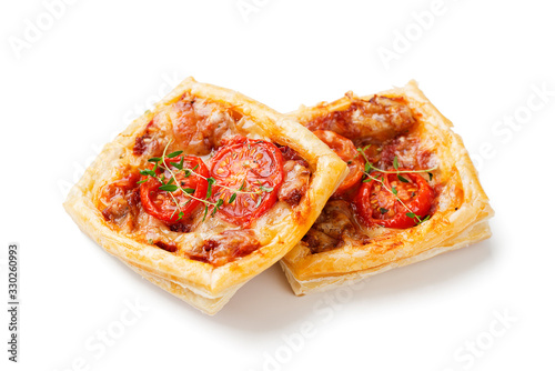 Puff pastry mini pies with cheese and tomatoes isolated on white background