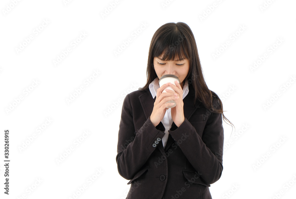Young Asian business woman in black suit with long hair holding A cup of coffee and drink on white background. ,studio isolated,Happy time Young Asian business woman in black suit with long hair holding A cup of coffee and drink on white background. ,studio isolated,Happy time