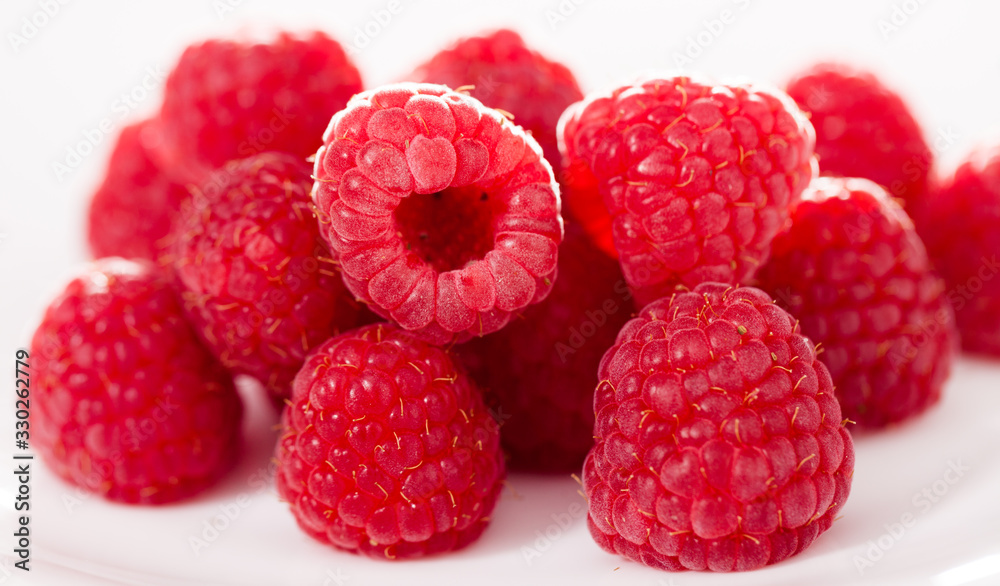 handful of raspberry berries on white background handful of raspberry berries on white background