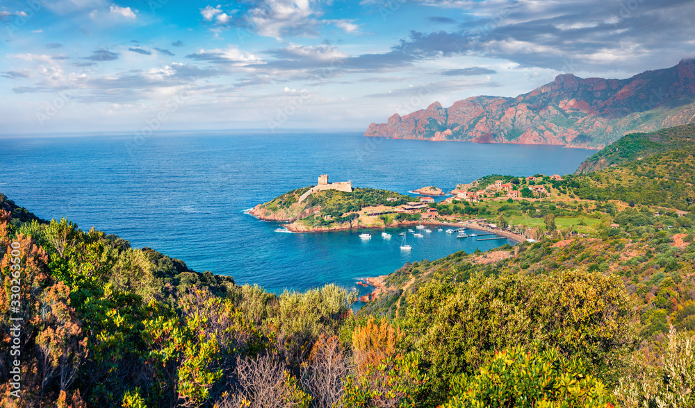 Marvelous morning view of Port de Girolata - place, where you can't get by car. Green sunny scene of Corsica island, France, Europe. Captivating Mediterranean seascape.