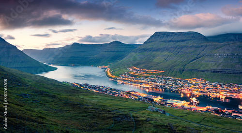 Fototapeta Impressive summer cityscape of Klaksvik town. Incredible evening scene of Bordoy island, Faroe, Kingdom of Denmark, Europe. Traveling concept background.