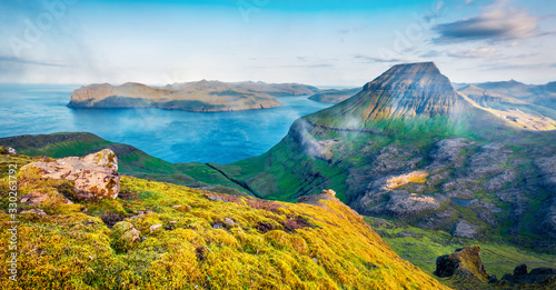 Misty morning view of popular tourist destination - Sornfelli. Stunning summer scene of Streymoy island. Aerial seascape of Atlantic ocean, Faroe Islands, Kingdom of Denmark, Europe. photo