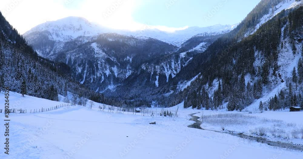 pan over snow covered mountain landscape in winter in austria near großarl pan over snow covered mountain landscape in winter in austria near großarl