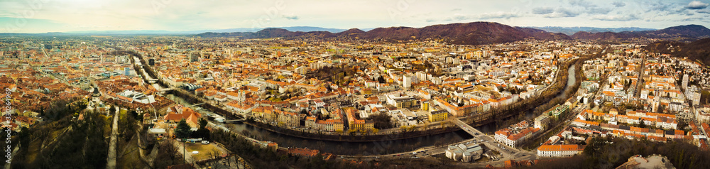 Aerial panorama view from Graz hill Schlossberg in Austria, cityscape with house roofs, mur river and all famous landscapes of tourist city.