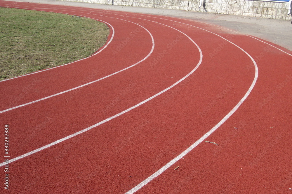 red color treadmill with white dividers around the stadium