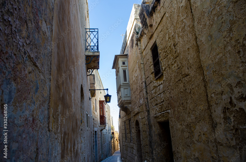 Back street in Mdina Malta with traditional stone houses