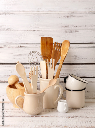 Baking kitchenware and baking products on white wooden background.