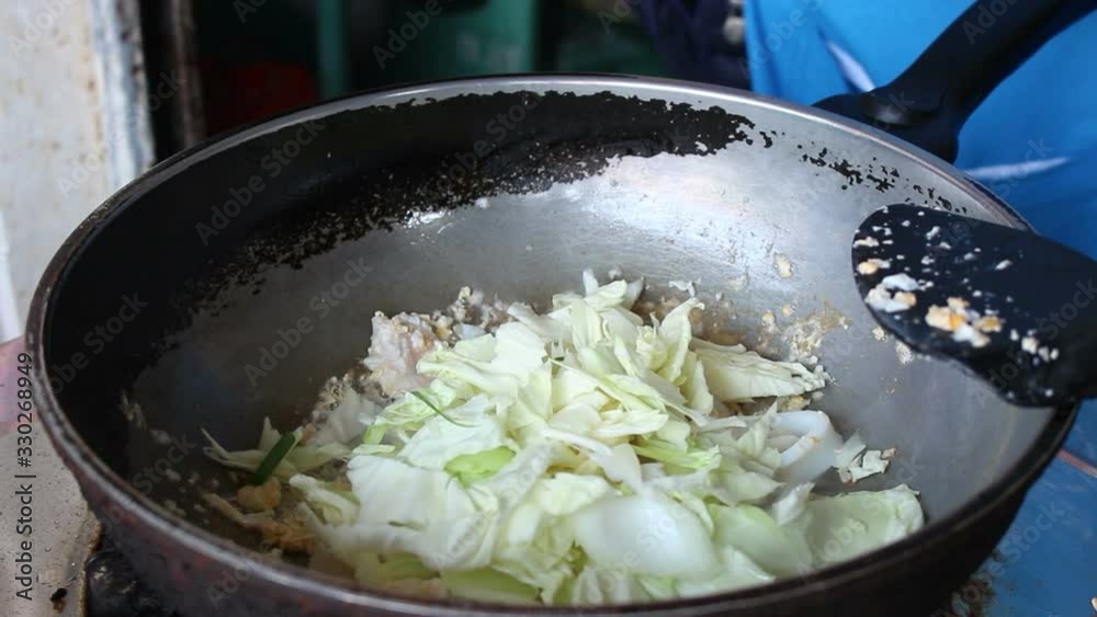 The cook is frying the seafood with vegetable The cook is frying the seafood with vegetable