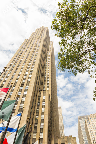 Rockefeller center, 30 Rockefeller Plaza (Comcast building), New York City, NY, USA. Beautiful low angle shot (human POV) of this historical american art deco style skyscraper. photo