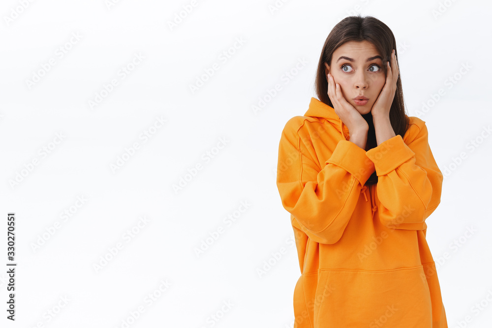 Shocked and amazed caucasian girl hear incredible news, process information, gossiping and looking left astonished, grab head cant believe something happened, stand impressed white background Shocked and amazed caucasian girl hear incredible news, process information, gossiping and looking left astonished, grab head cant believe something happened, stand impressed white background