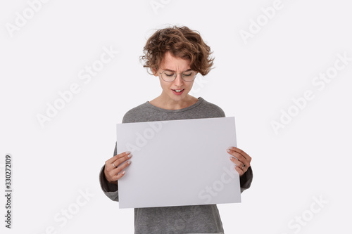 Smiling young woman with eyeglass holding empty blank paper board with copy space for text. photo