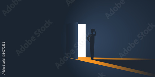 Standing Business Man in a Dark room, Open Door with Light Going Through It - New Possibilities, Hope Concept, Overcome Problems, Solution Finding