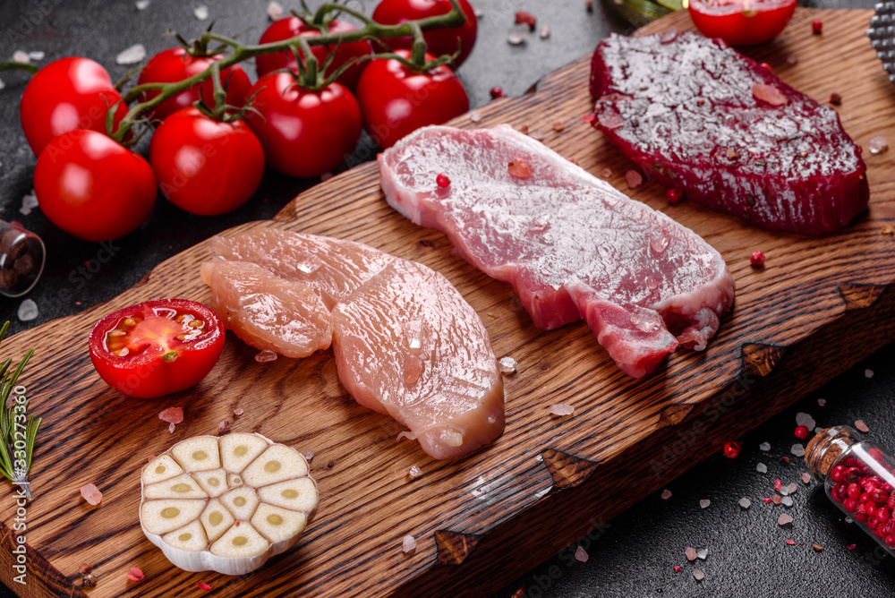 Fresh juicy steak of beef, pork and chicken with vegetables ready to cook Fresh juicy steak of beef, pork and chicken with vegetables ready to cook