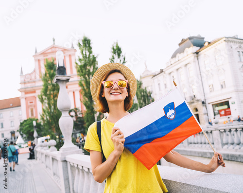 Quadro su tela Woman tourist with slovenian flag in Ljubljana, Slovenia, Europe.