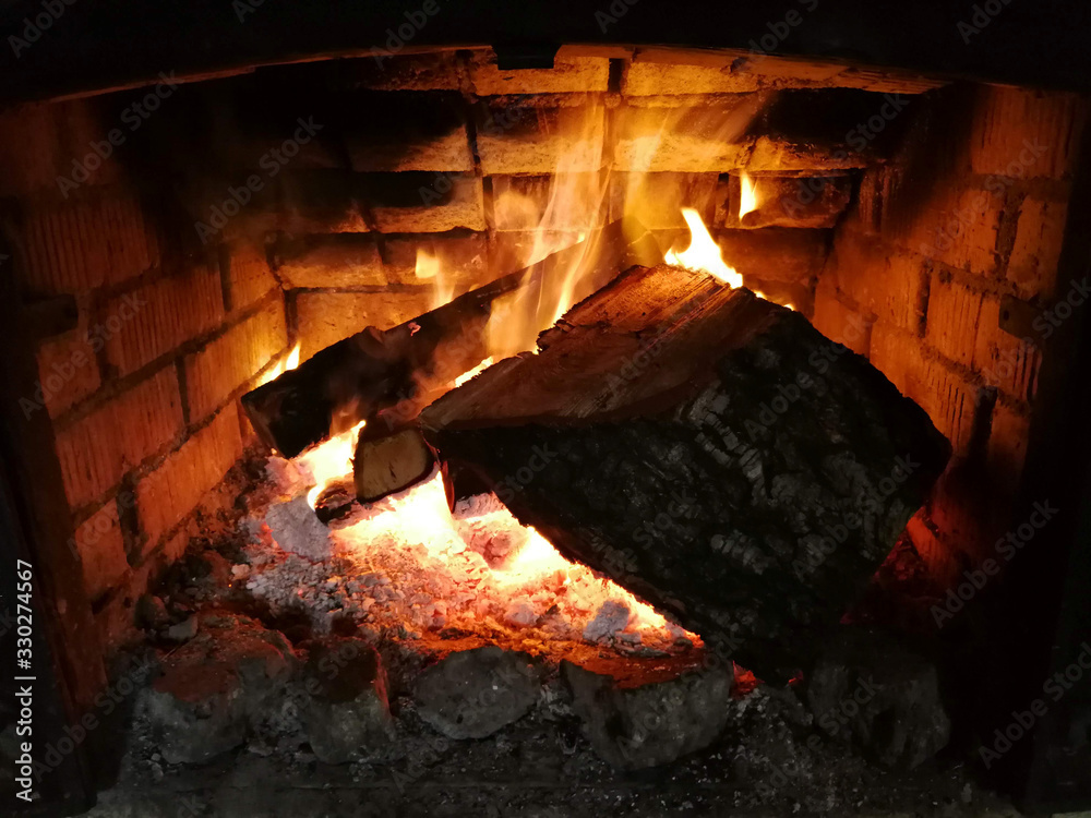 Fototapeta premium Burning wood in the fireplace close-up