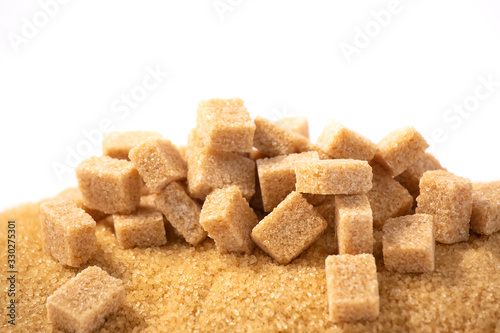Brown sugar in a wooden bowl or wooden spoon Sugar for health Use for cooking or desserts on white and sugar backgrounds.