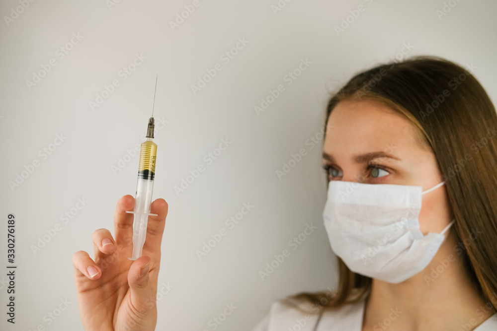 Masked doctor with an injection in his hands Masked doctor with an injection in his hands