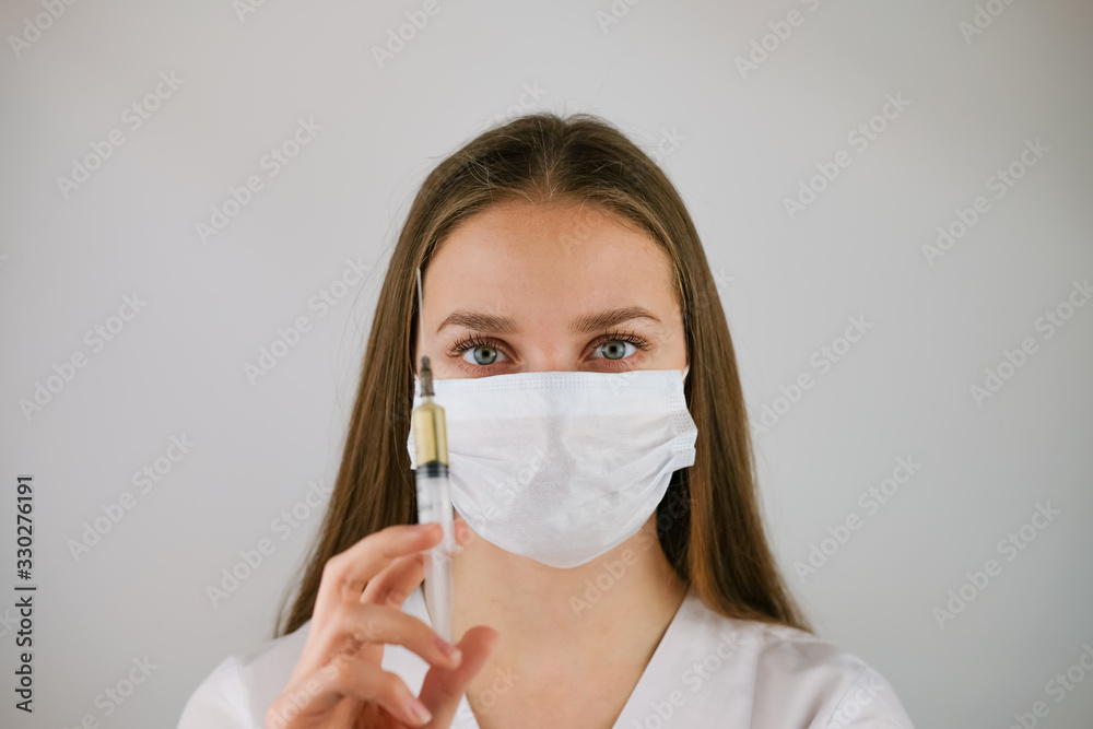Masked doctor with an injection in his hands Masked doctor with an injection in his hands
