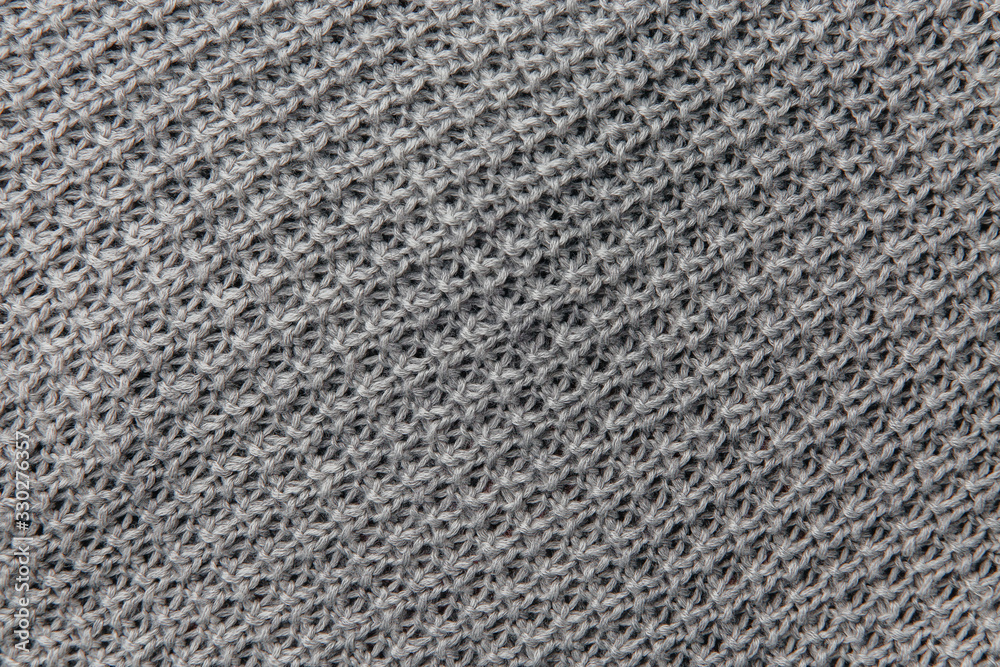 Grey knitted fabric texture. Product from wool. Handwork Grey knitted fabric texture. Product from wool. Handwork