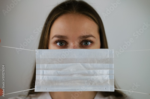 Medical mask in the hands of a doctor photo