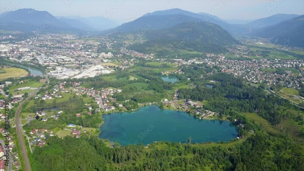 Panoramic aerial view of a small city with a view of a large lake mountains and the sky Panoramic aerial view of a small city with a view of a large lake mountains and the sky