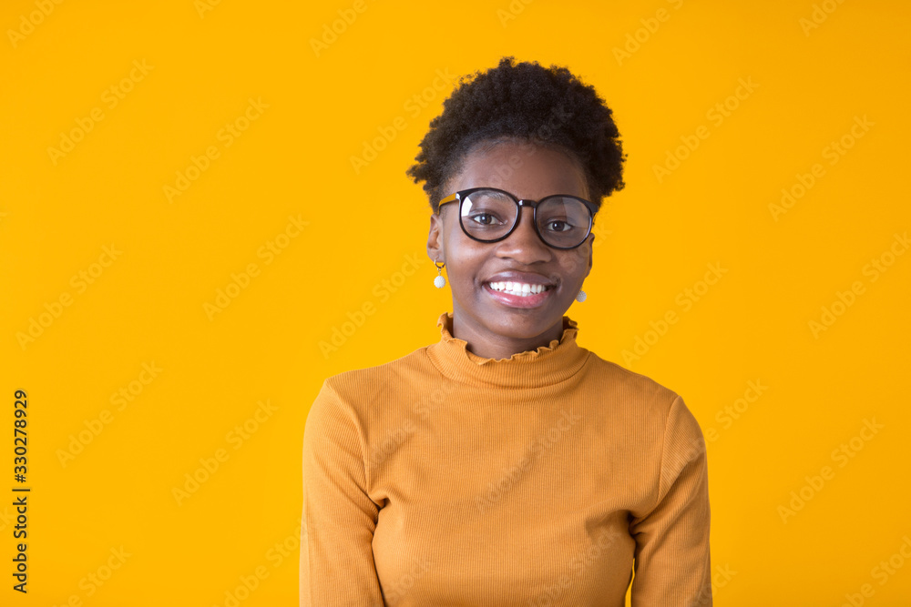 beautiful young african woman in glasses on a yellow background beautiful young african woman in glasses on a yellow background