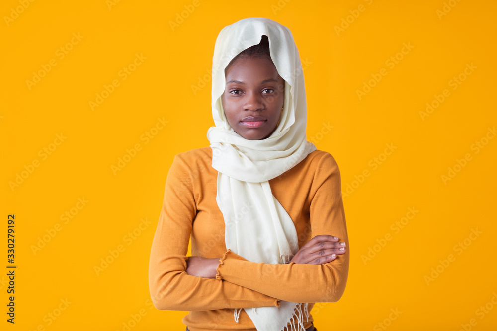 beautiful young african woman on yellow background with muslim shawl beautiful young african woman on yellow background with muslim shawl