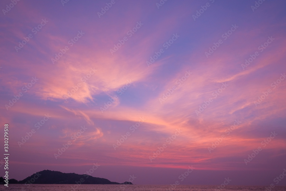 Stunning purple sunset on a tropical beach.