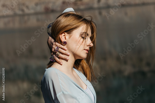 Romantic portrait of beautiful model wearing handmade jewellery,  rings, necklace, bracelet. Outdoors portrait on sunny day.   photo