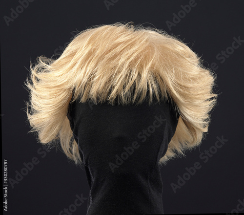 Short blonde hair wig on black background