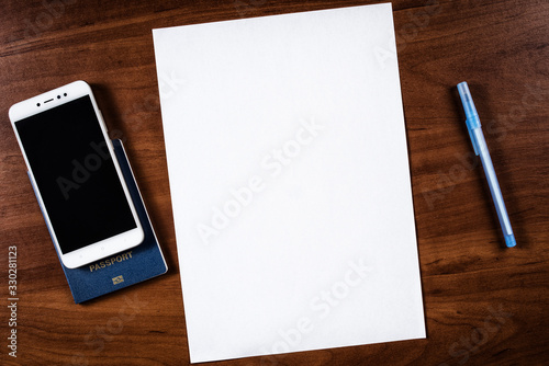 a sheet of A4 paper on the table and a passport with a pen, a sheet of A4 paper and a passport with a mobile phone, a blank A4 sheet and a passport with a pen near it, not filled sheet A4