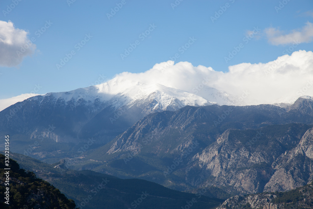 the mountain tops were covered with snow after the rains in the valley