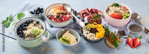 Bowls of oatmeal with berries and fruits for healthy breakfast. Food with vitamins, minerals and antioxidants. Top view with copy space