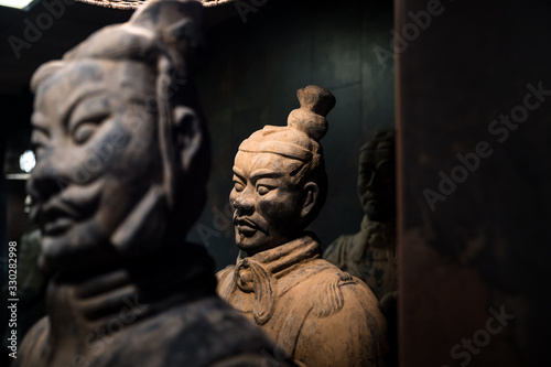 Vintage Buddhist sculptures in dark room