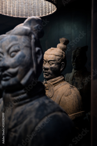 Vintage Buddhist sculptures in dark room