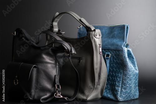 leather handbags of different colors on a black background side view, women's vintage leather handbags on black background, women's leather bags of different colors, women's handbags side view