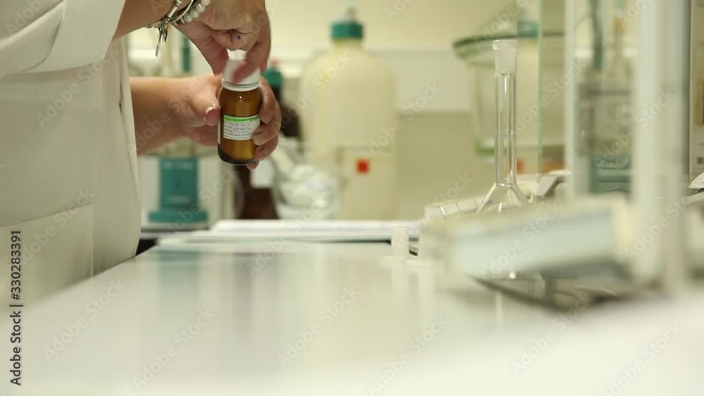 scientist closing samples bottle in laboratory scientist closing samples bottle in laboratory