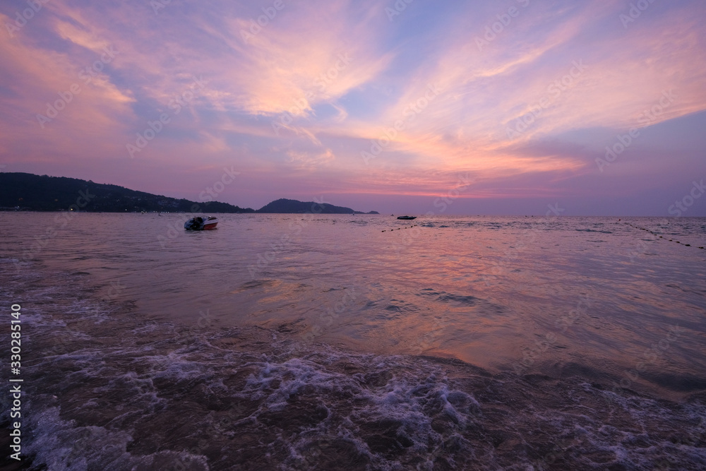 Ocean shore in purple sunset. Twilight.