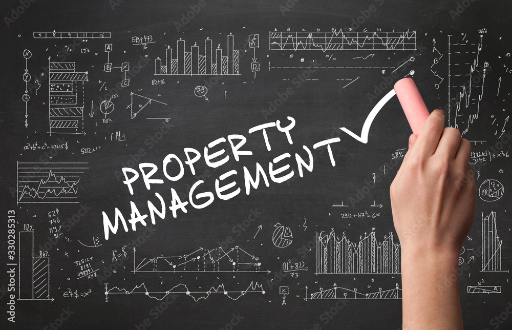 Fototapeta premium Hand drawing PROPERTY MANAGEMENT inscription with white chalk on blackboard, new business concept