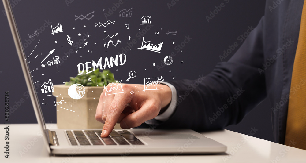 Businessman working on laptop with DEMAND inscription, modern business concept Businessman working on laptop with DEMAND inscription, modern business concept