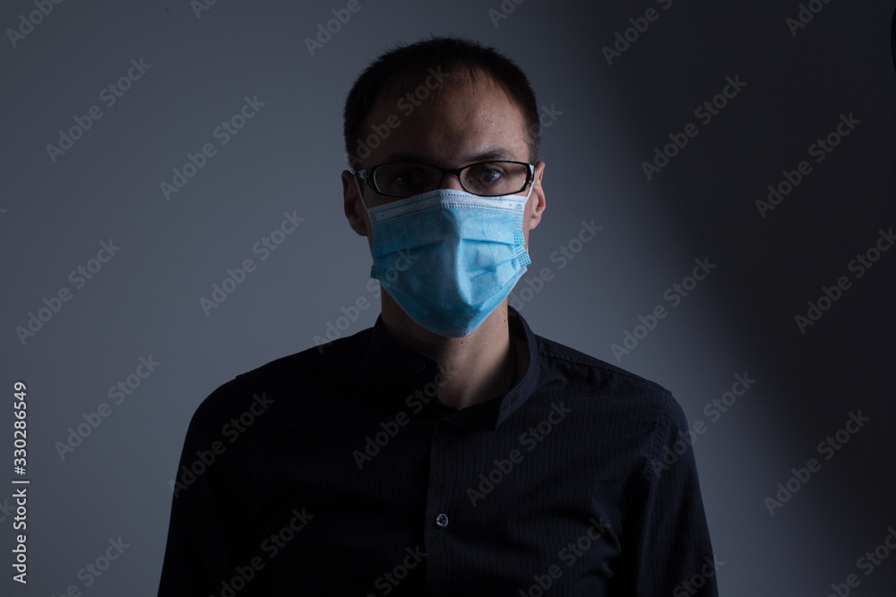 Strong man wearing mask to prevent flu virus and dust air pollution on white background