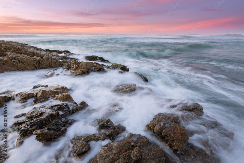 Obraz premium A beautiful seascape photographed just after sunset on the Marina beach in South Africa.