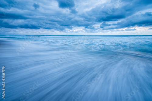 A beautiful seascape taken on an overcast day near the Marina Beach in South Africa. A long exposure helped blur the water to create a sense of motion.