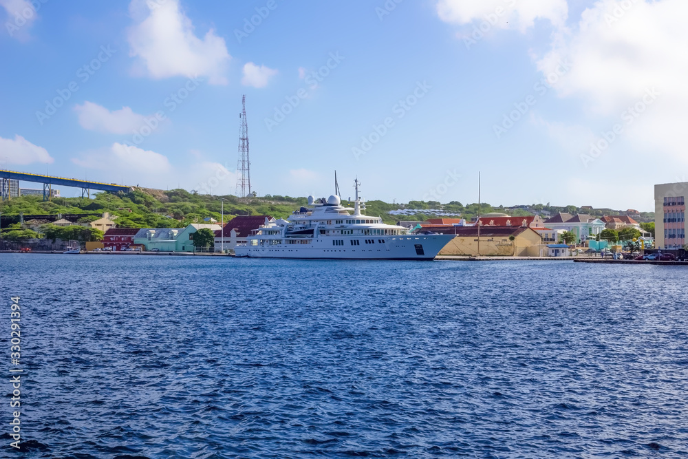 Massive luxury yacht docked near bridge on Curacao
