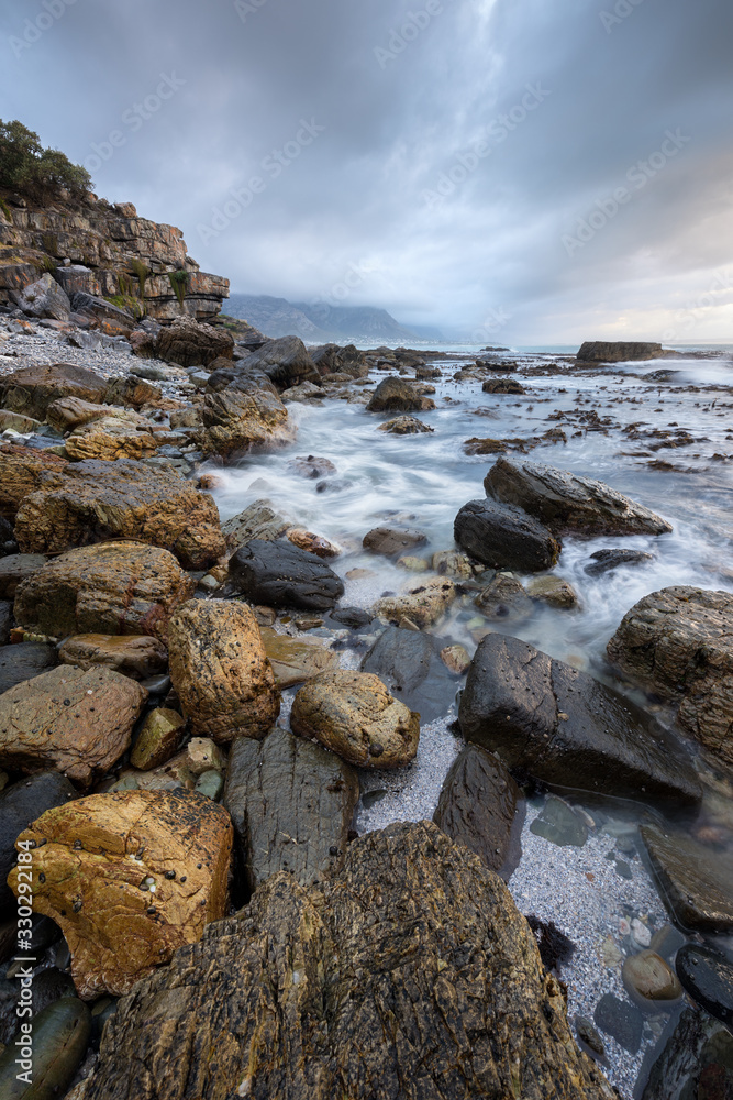 A beautiful vertical moody seascape taken in hermanus, South Africa, on a stormy, cloudy afternoon.