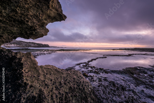 A beautiful early evening seascape photographed on a stormy day after sunset in Arniston, South Africa. photo