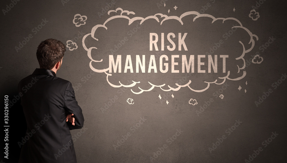 businessman drawing a cloud with RISK MANAGEMENT inscription inside, modern business concept businessman drawing a cloud with RISK MANAGEMENT inscription inside, modern business concept