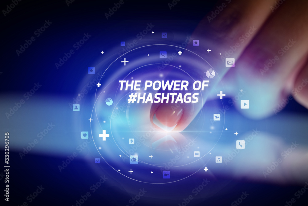 Finger touching tablet with social media icons and THE POWE OF #HASHTAGS