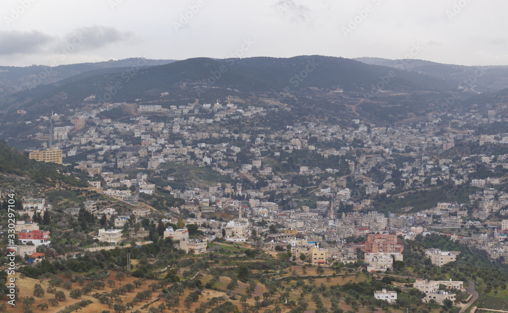 Landscape view of the city of Ajlun in the North of Jordan in the Spring with lush countryside and olive groves